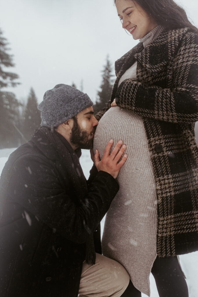 Expecting couple in the snow